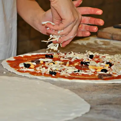 Hands stretching pizza dough