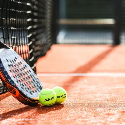 Padel racket and ball on the court
