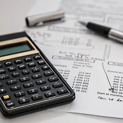 Calculator and pen on a statement