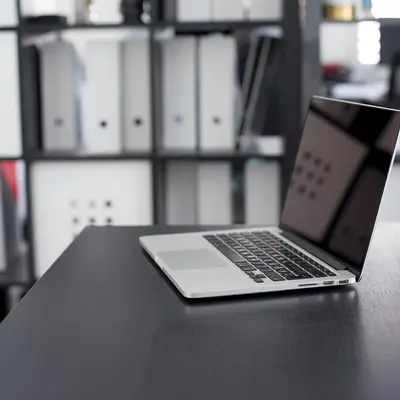 Laptop and files on an office desk